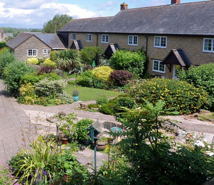 Photo: Bower Court, Yetminster, showing individual gardens forming an open space 