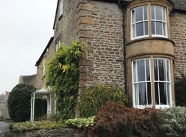 Photo: Junction of Queen Street with the High Street, Yetminster, showing corner treatment with windows on    both sides